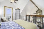 Lofted bedroom with a private balcony with bistro set